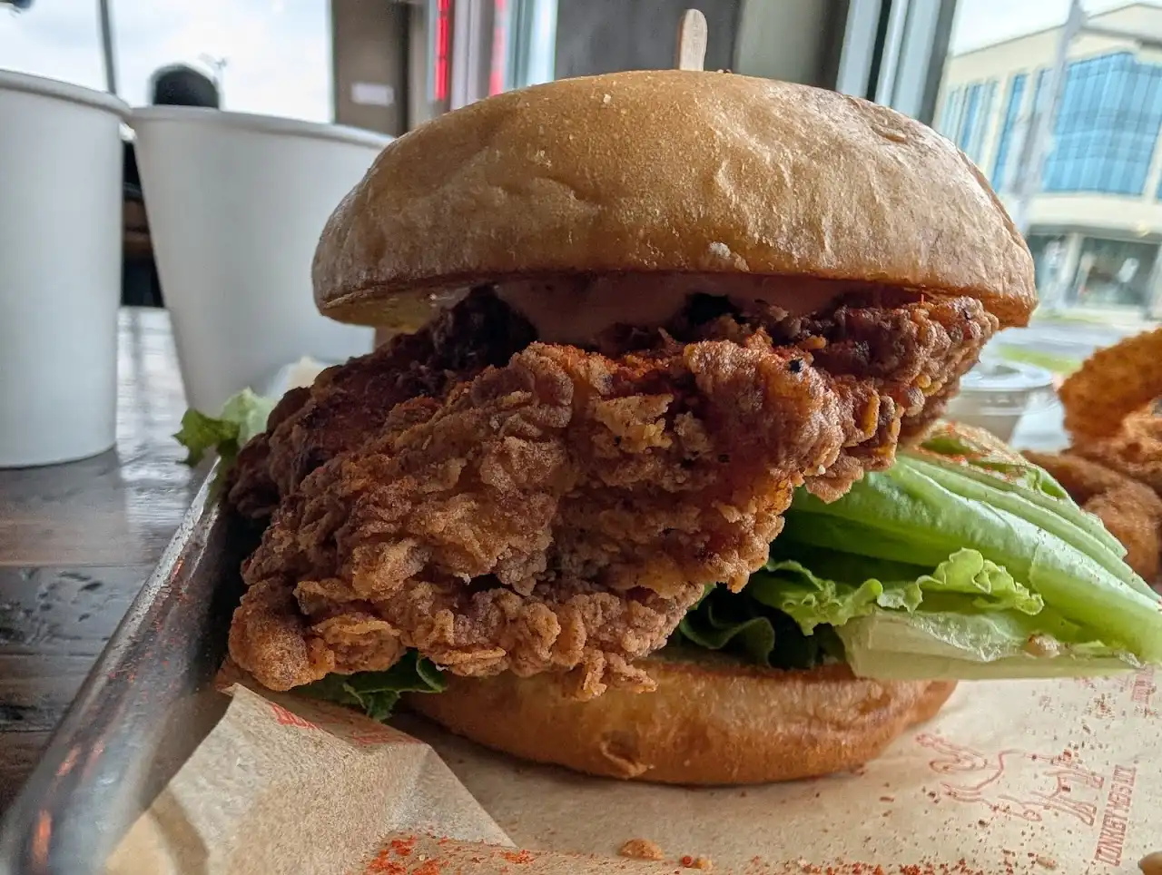 Crispy Korean fried chicken sandwich with lettuce on a Hawaiian bun