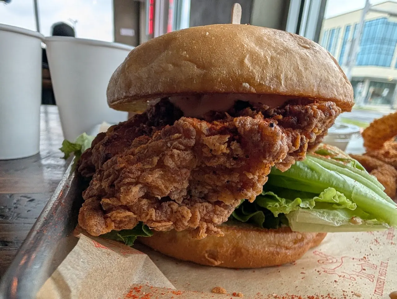 Crispy Korean fried chicken sandwich with lettuce on a Hawaiian bun