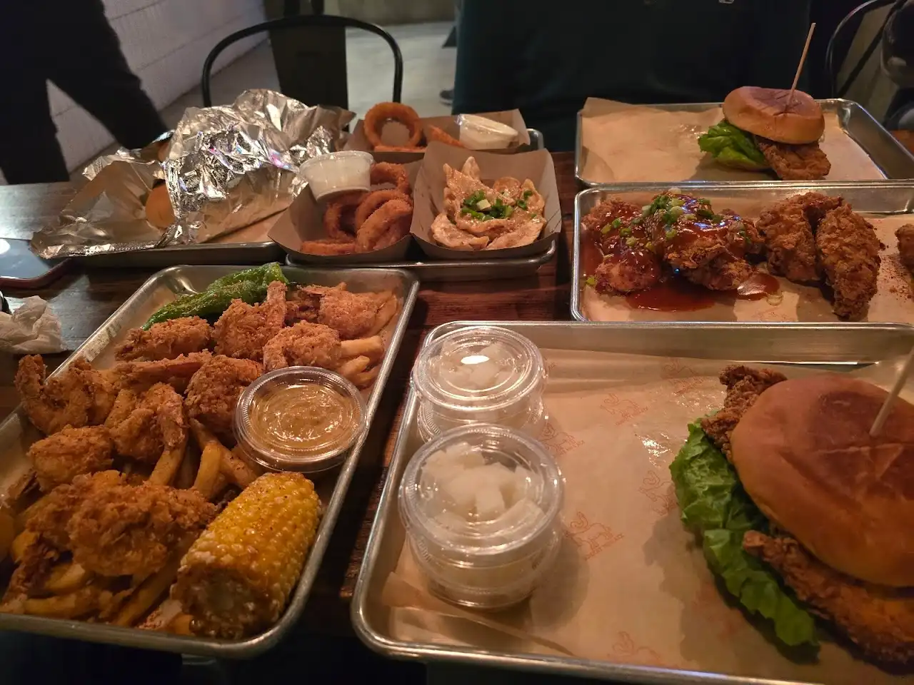 A full spread of tenders, wings, sandwiches, onion rings and sides