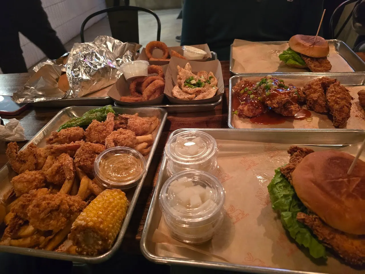 A full spread of tenders, wings, sandwiches, onion rings and sides