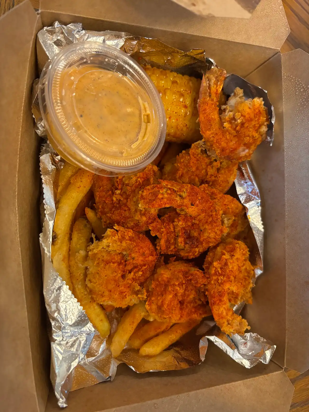 Double-fried shrimp basket with fries, corn and dipping sauce