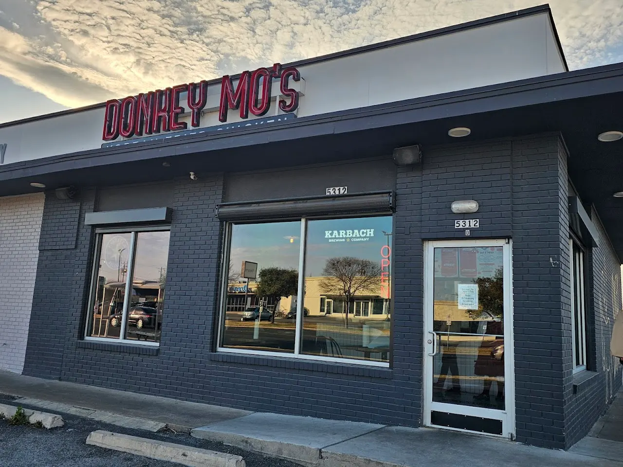 Donkey Mo's storefront with neon sign on Airport Blvd in Austin